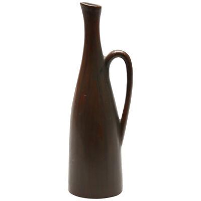 A stoneware vase in a brown color