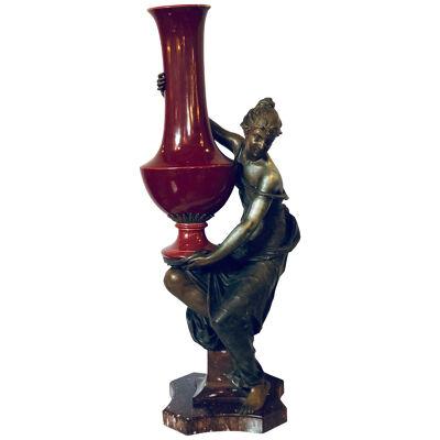 Spelter Figure of a Water Bearer on a Pedestal / Marble with Red Glazed Vase