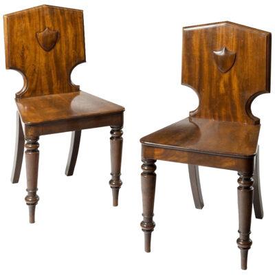 A Pair Of Regency Period Cuban Mahogany Hall Chairs