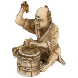 Netsuke representing a barrel maker 