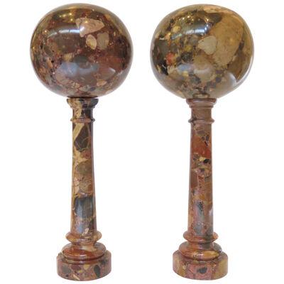 A Pair of Grand Tour Specimen Marble Orbs Atop Marble Columns