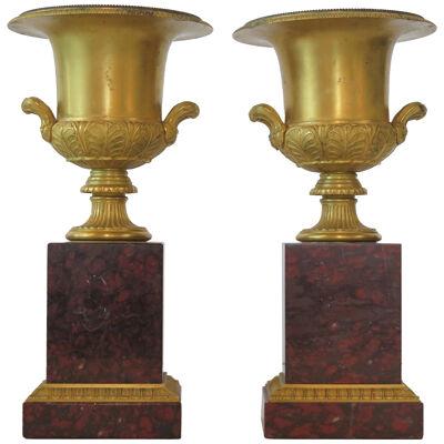 A Pair of Grand Tour Gilt Bronze Campagna Urns on Rouge Griotte Marble Plinths