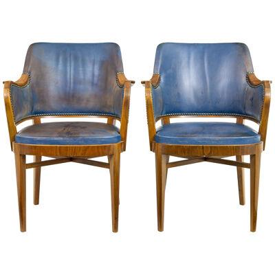 PAIR OF MID 20TH CENTURY TEAK AND LEATHER ARMCHAIRS