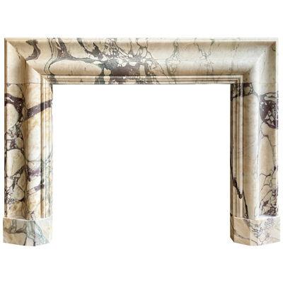 A Large Breche Marble Bolection Fireplace Mantel