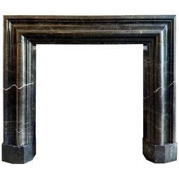 A Large Reclaimed Black Marble Bolection Fireplace 