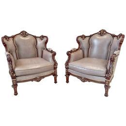 Italian Rococo Style Carved Wood Bergere chair with Leather upholstery, a Pair