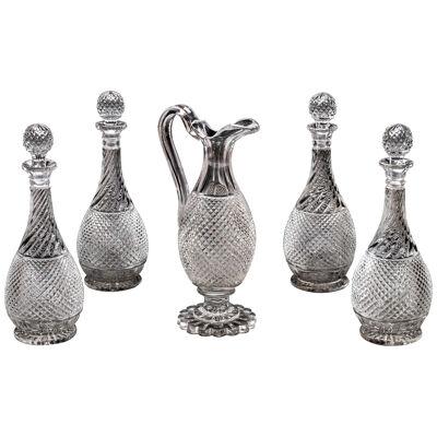 A SET OF FOUR DIAMOND & SWIRL CUT DECANTERS WITH CORRESPONDING WINE EWER