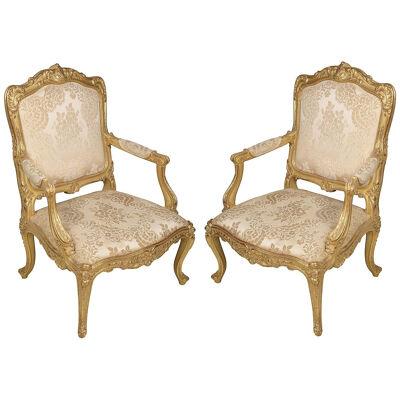 Pair 19th Century French carved giltwood Louis XVI style arm chairs.