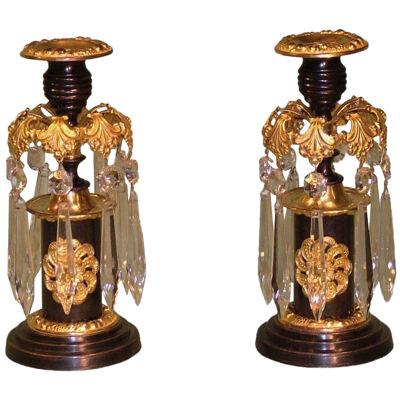 A pair of 19th Century bronze and ormolu Lustre Candlesticks.