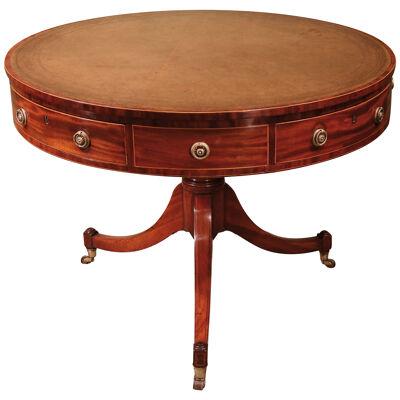 A George III period mahogany revolving drum table