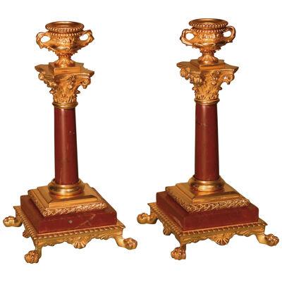 A pair of late 19th century ormolu and marble candlesticks