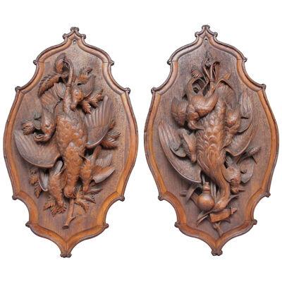 A large pair of 19th Century black forest plaques 