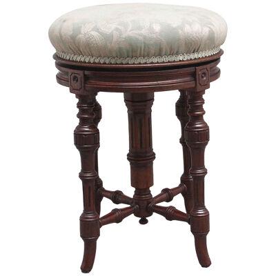19th Century walnut piano stool with an adjustable seat