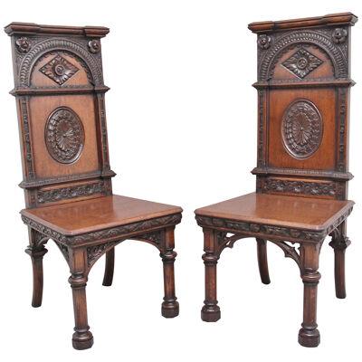 Near pair of 19th Century carved oak Gothic hall chairs