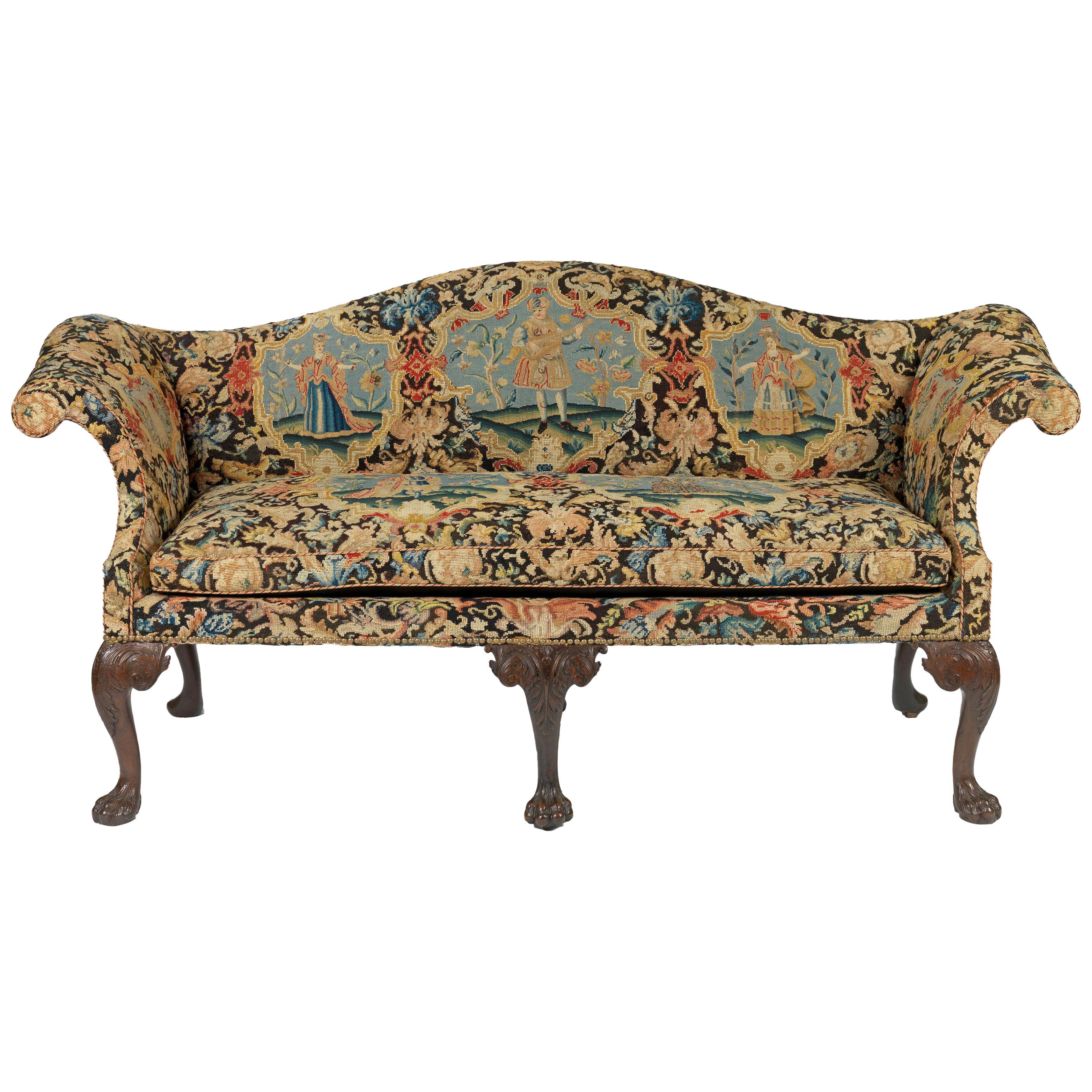 A George II Mahogany Settee upholstered in Needlework 