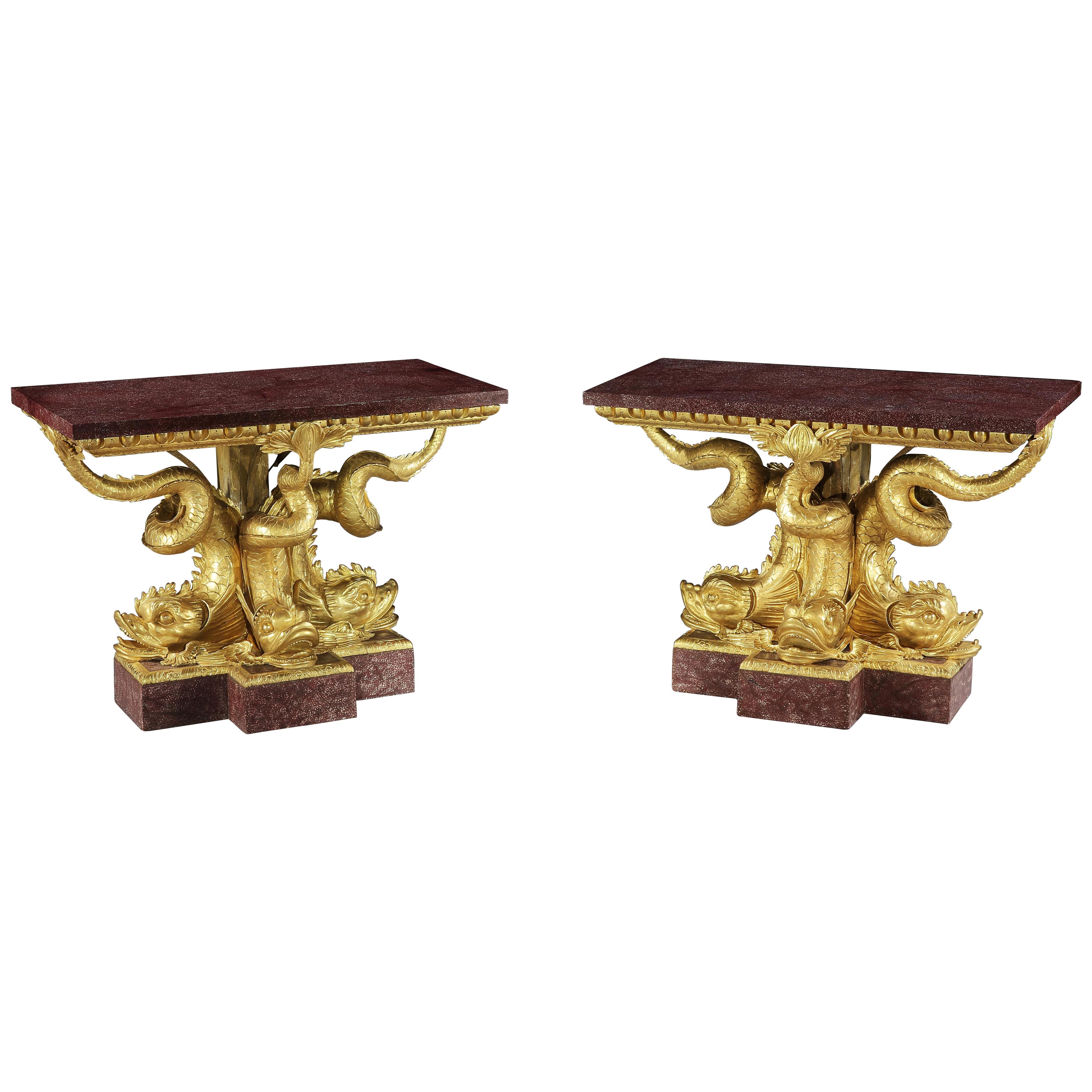 A Magnificent Pair of Regency Giltwood and Porphry Dolphin Tables
