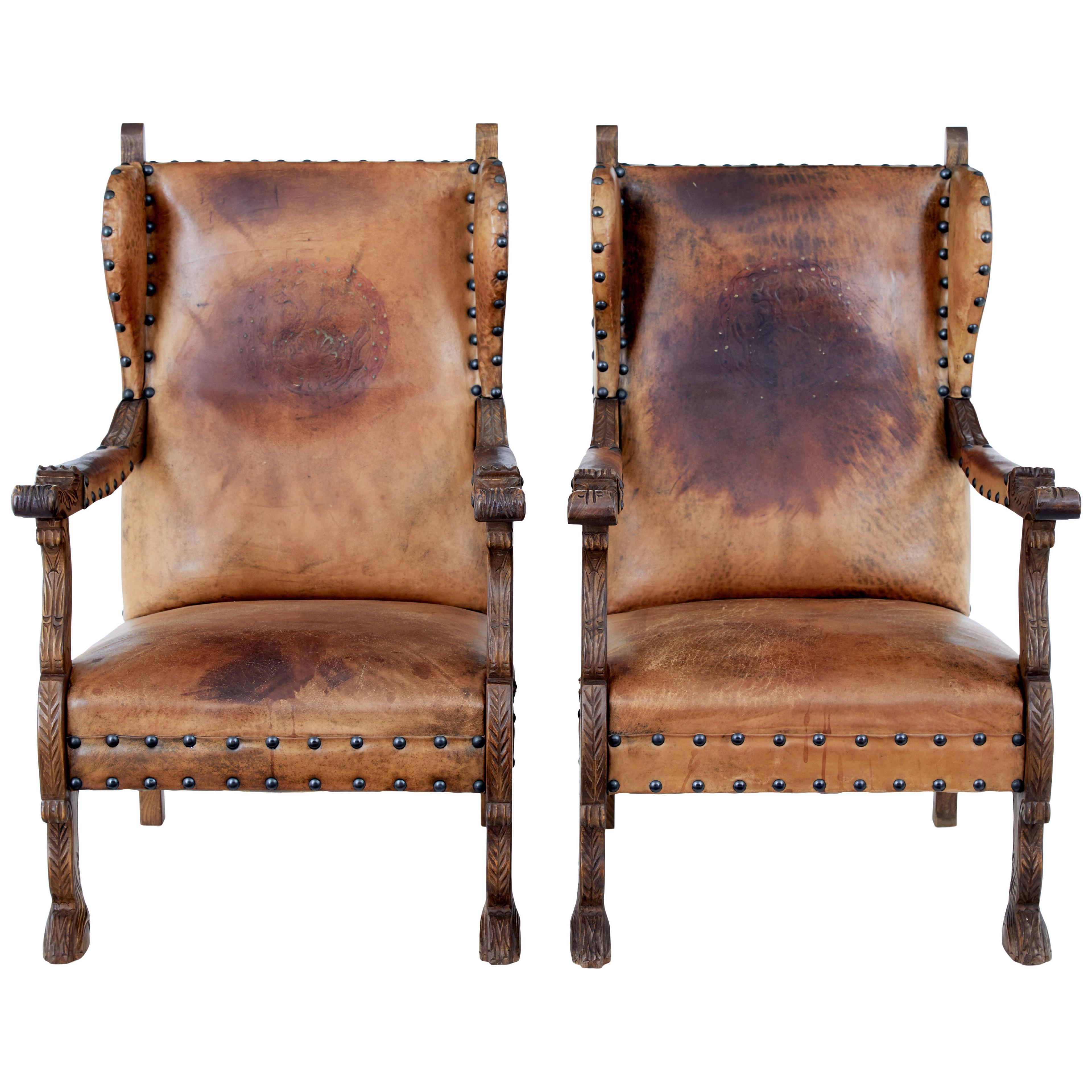 PAIR OF 19TH CENTURY CARVED OAK AND LEATHER ARMCHAIRS