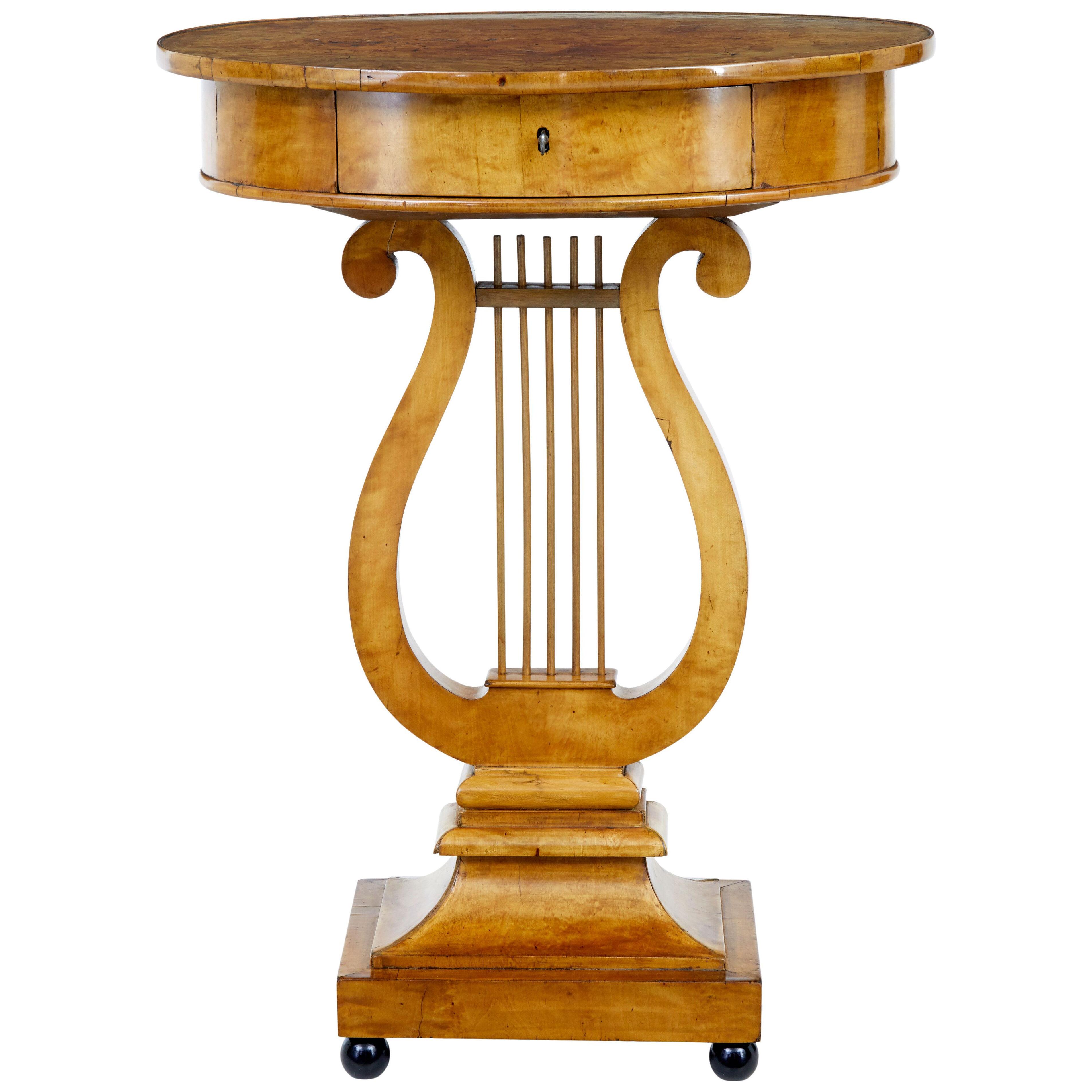 EARLY 19TH CENTURY BIRCH EMPIRE LYRE FORM SIDE TABLE