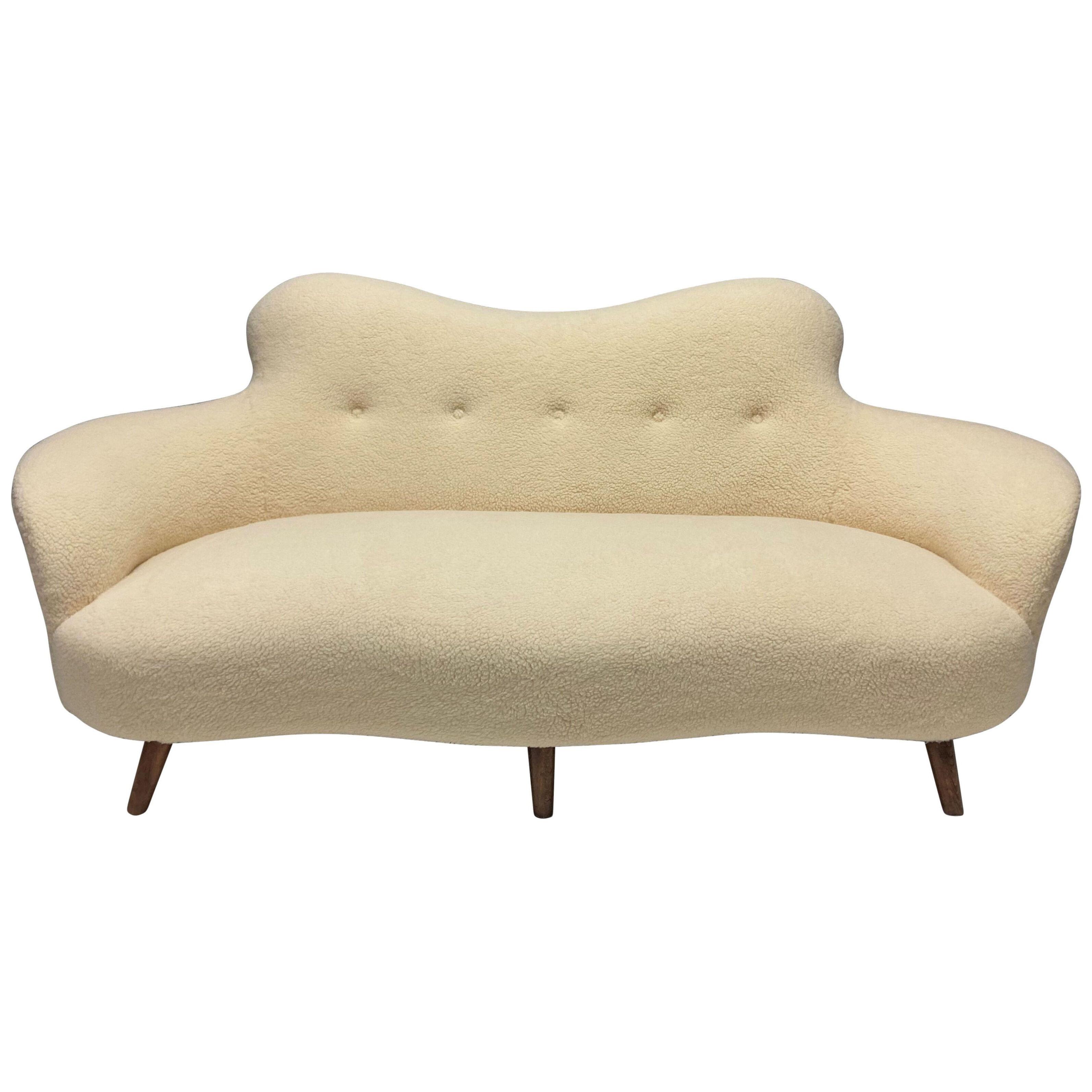 A SCULPTURAL MID-CENTURY ITALIAN SOFA IN FAUX LAMBSWOOL
