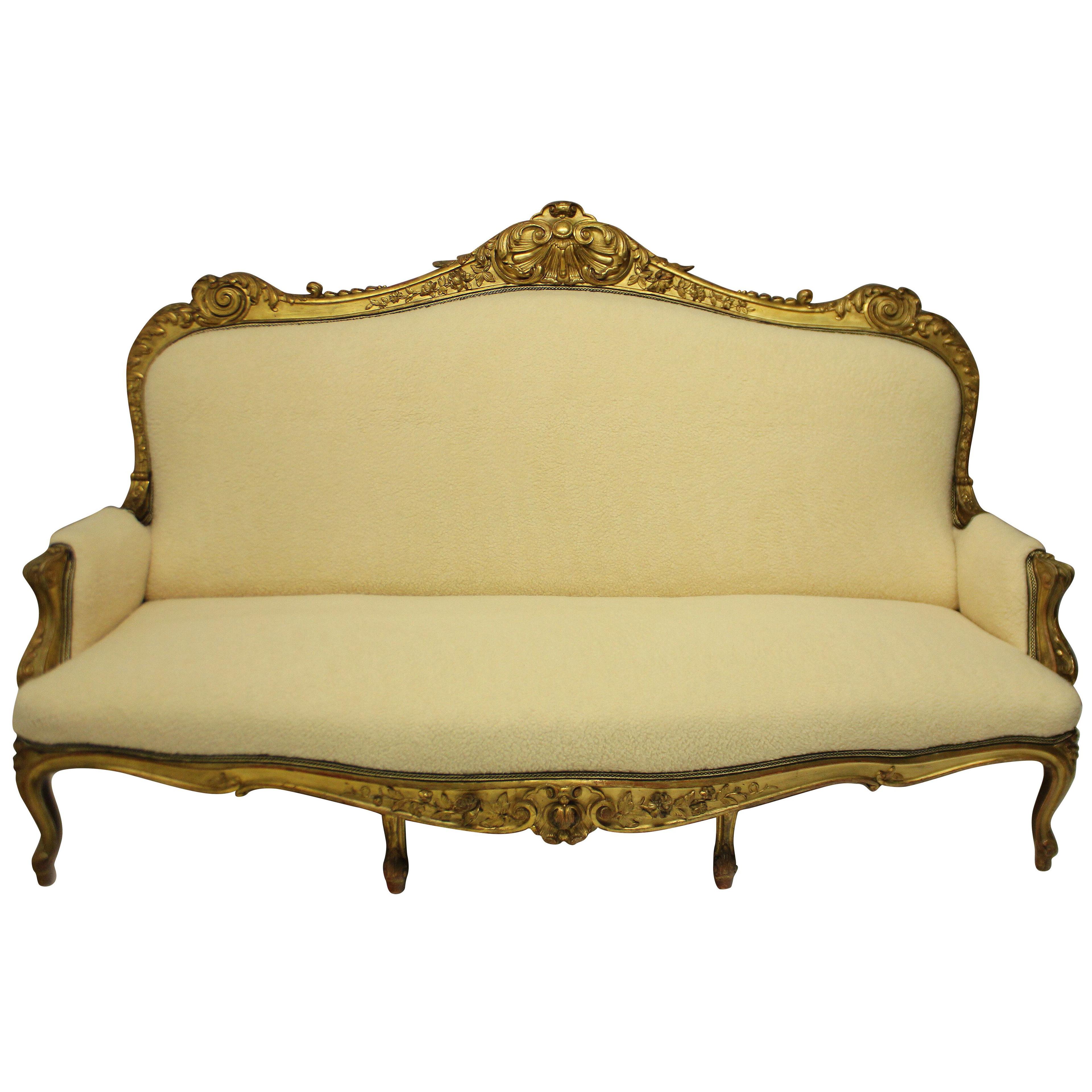 A LARGE ENGLISH EARLY XIX CENTURY GILTWOOD SETTEE