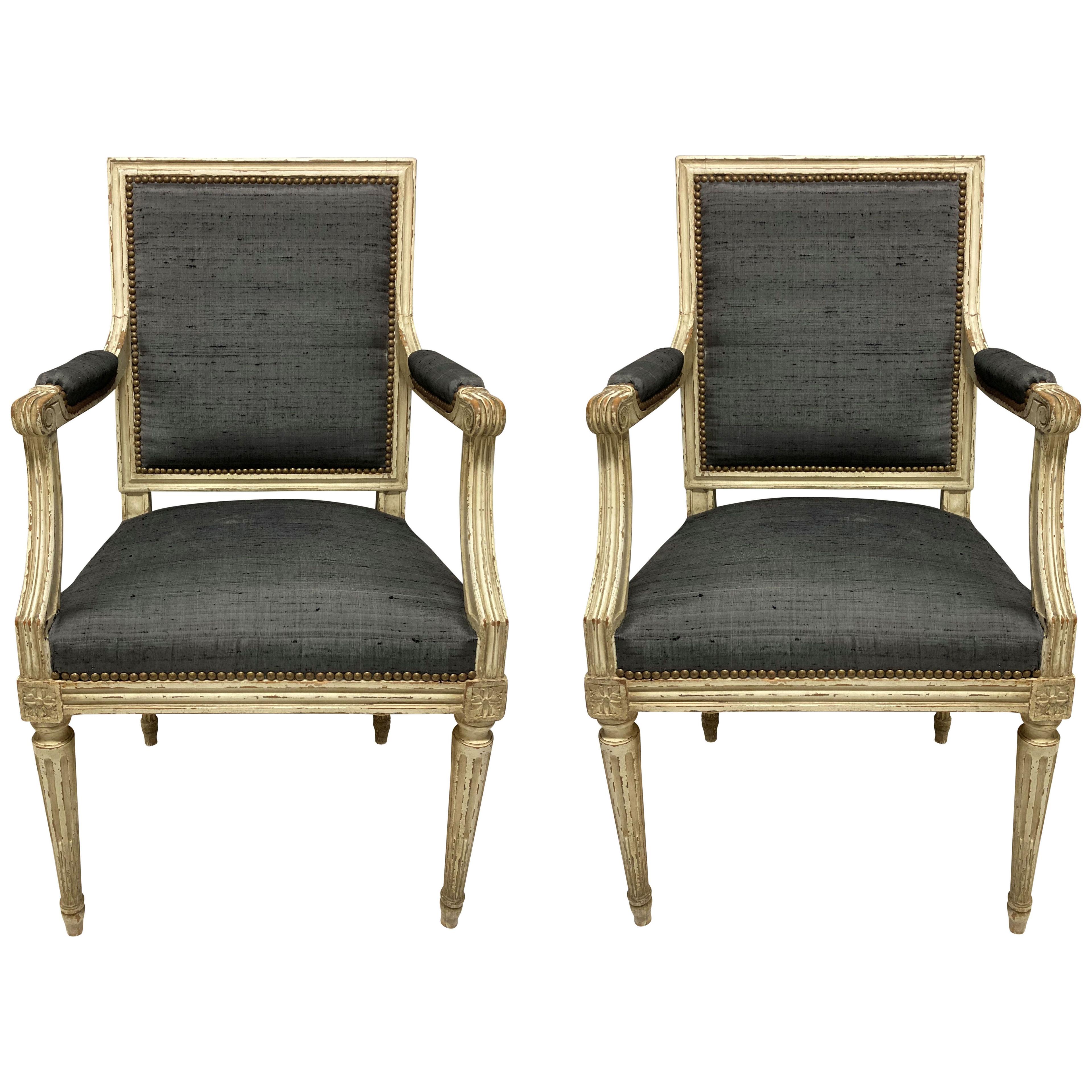 A PAIR OF PAINTED LOUIS XVI STYLE ARMCHAIRS