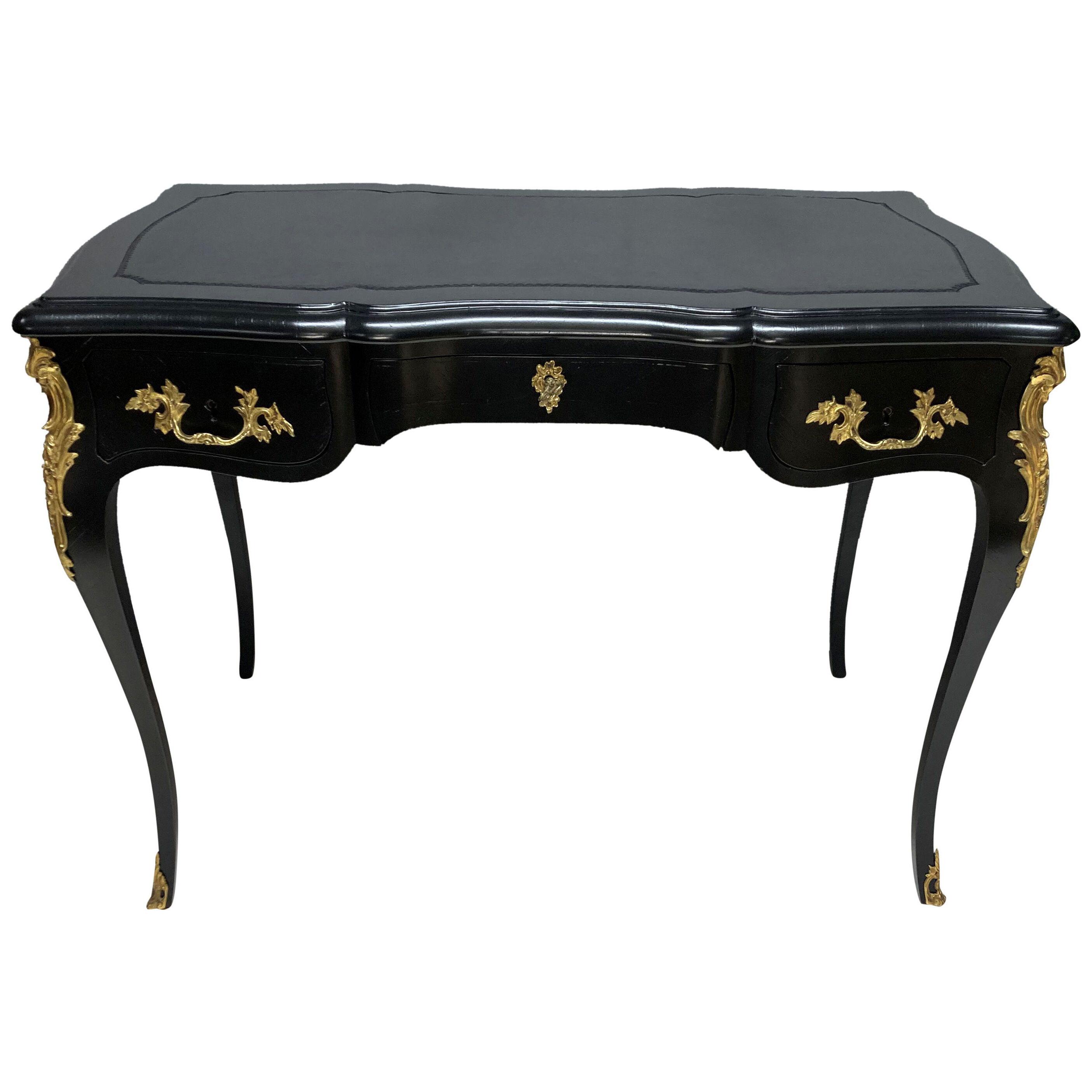 A BLACK LACQUERED LOUIS XV STYLE WRITING TABLE