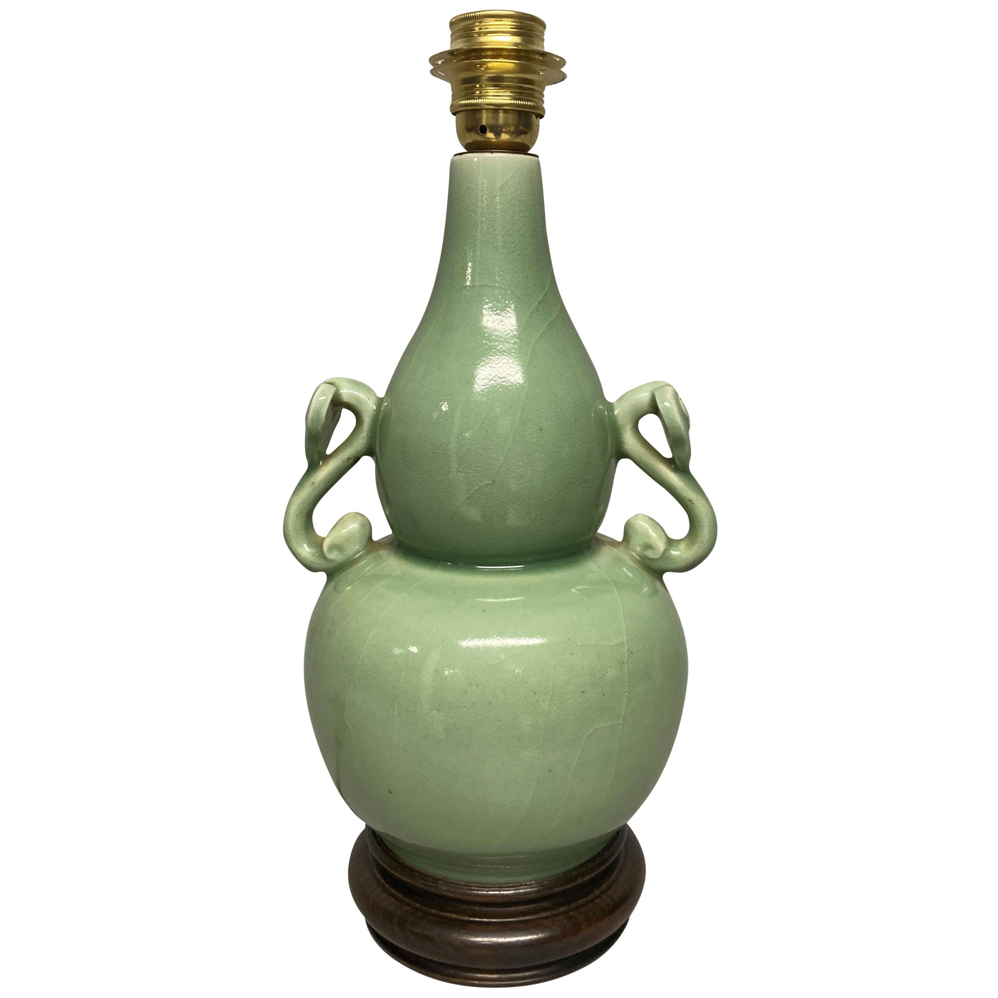 A CHINESE CELADON TWIN HANDLED VASE LAMP