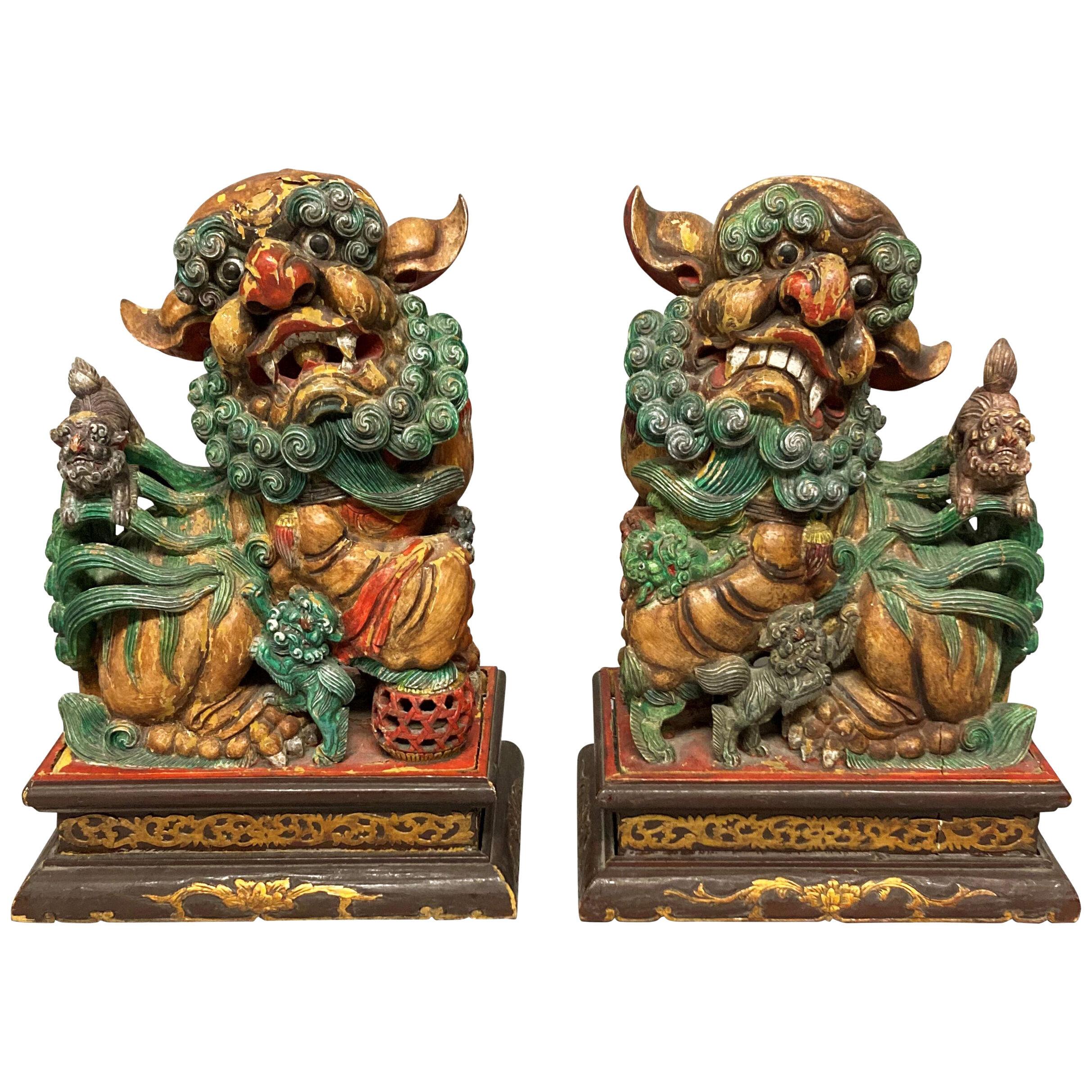 A PAIR OF CHINESE POLYCHROME PAINTED FOO DOGS