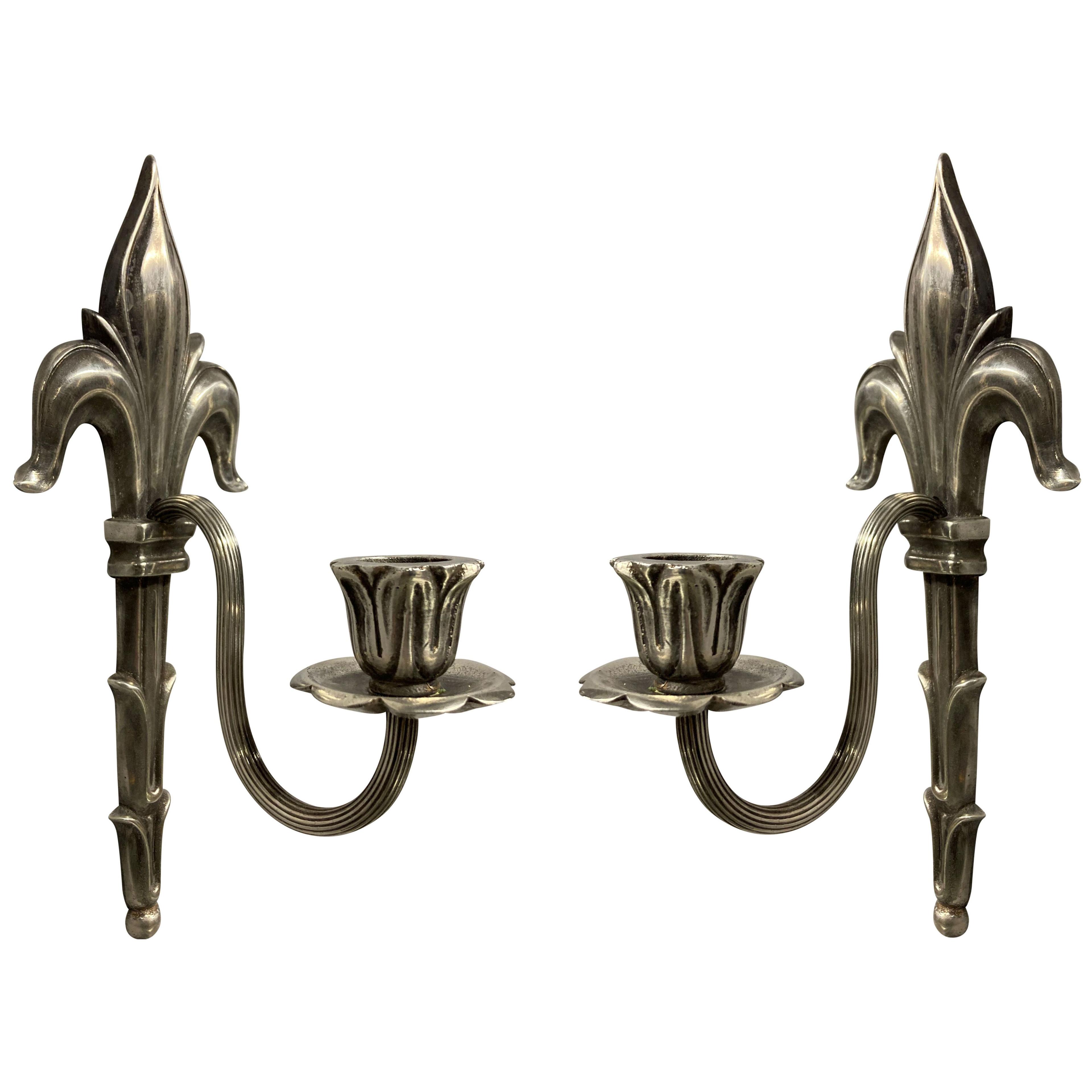 A PAIR OF EDWARDIAN SILVER PLATED SINGLE ARM SCONCES