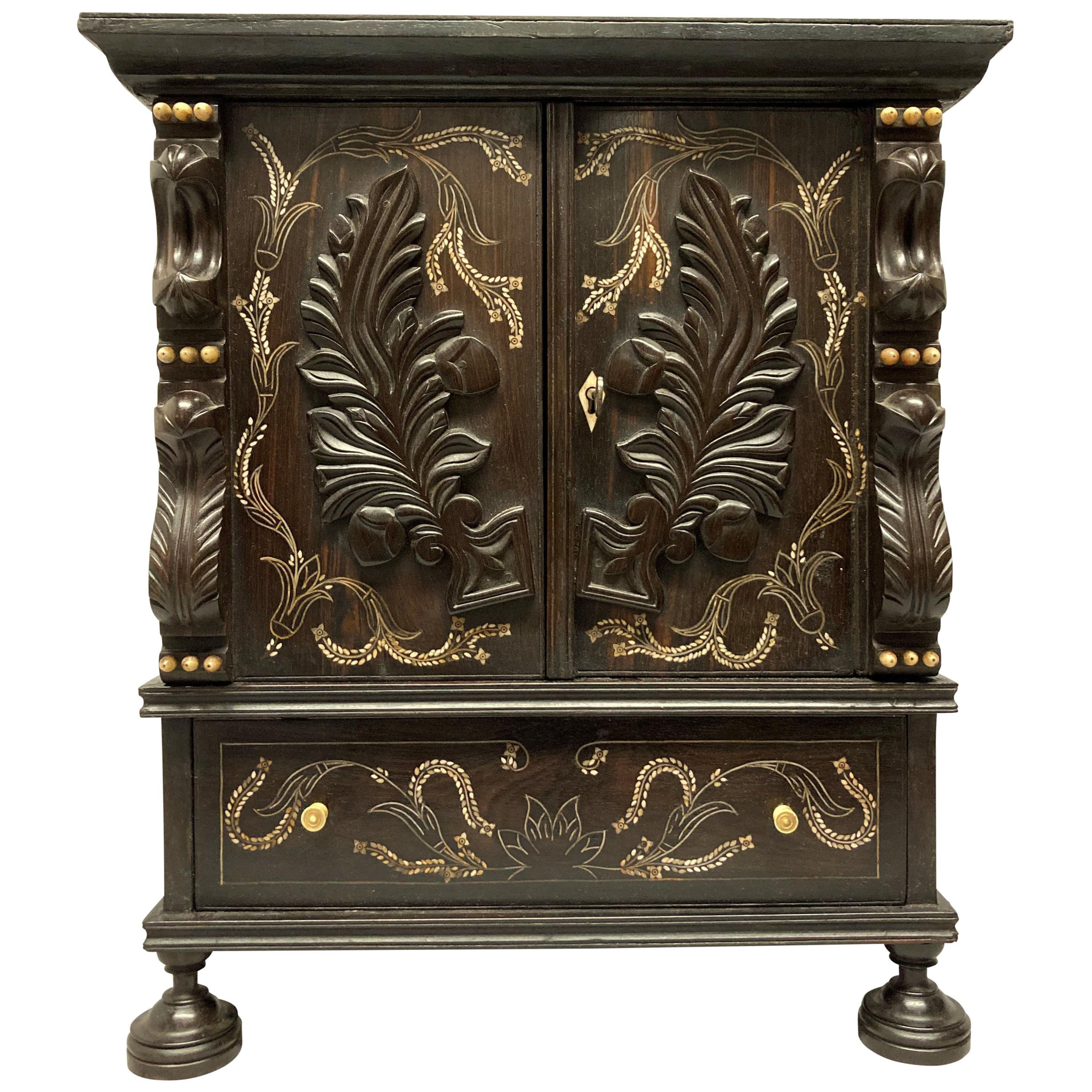 AN EARLY XIX CENTURY ANGLO-INDIAN CABINET IN EBONY