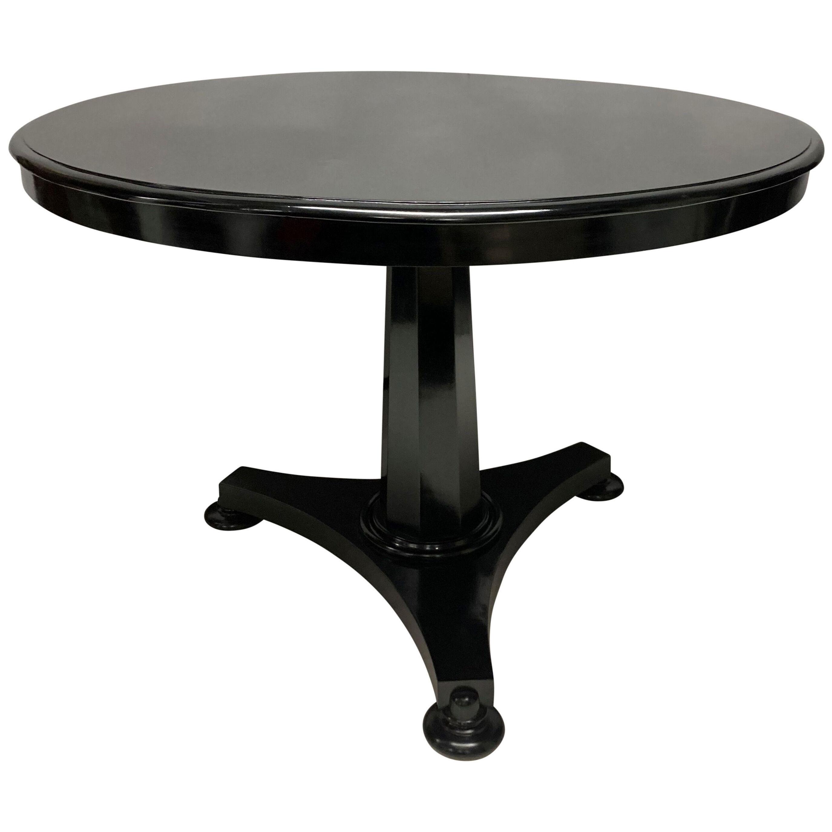 A BLACK LACQUERED GUERIDON TABLE