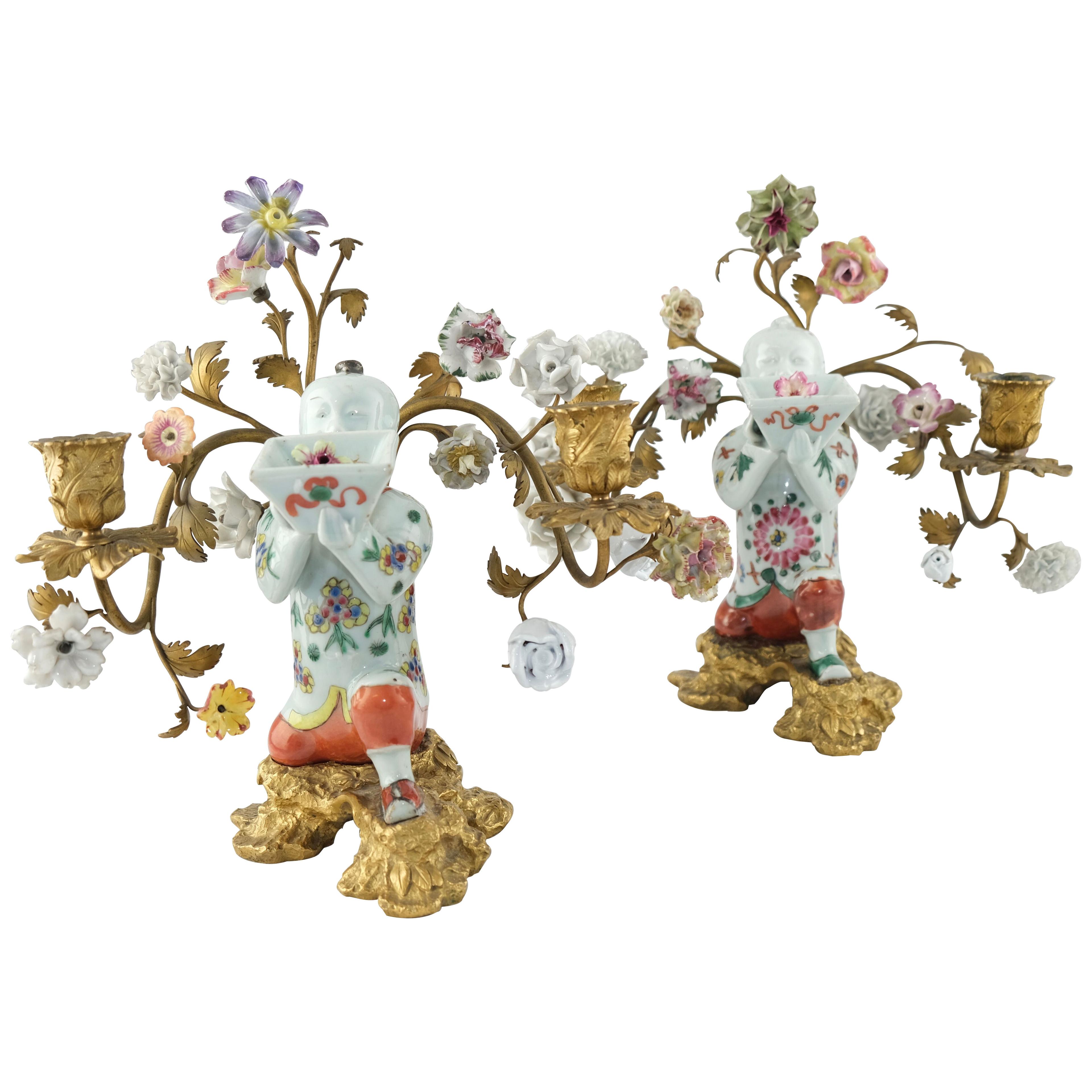 A pair of candelabra. Chinese 18th c porcelain mounted with 19th c bronzes.