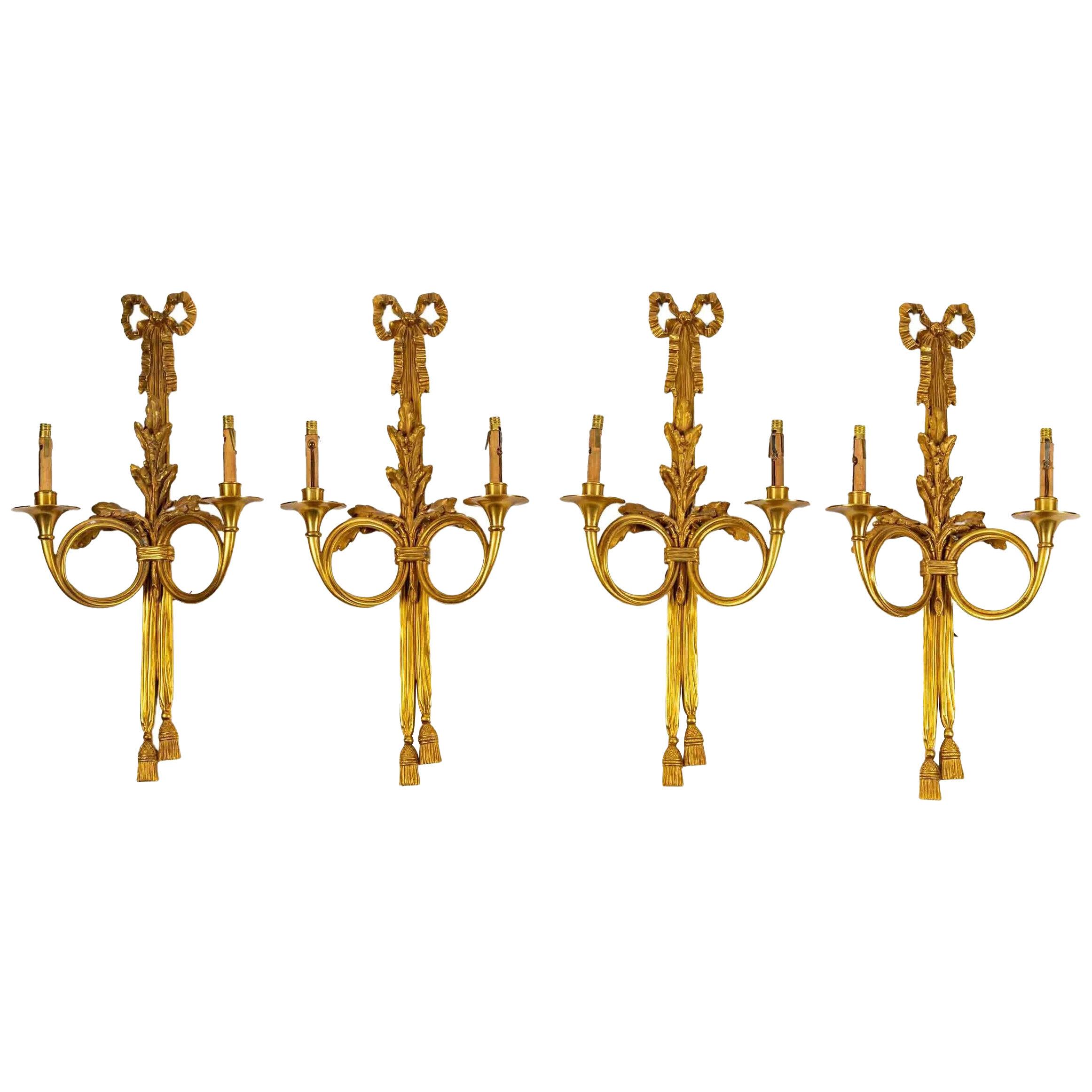 A set of four Louis XVI style gilt bronze sconces