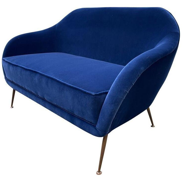 A1950s Italian two seater sofa with brass legs newly upholstered in blue velvet