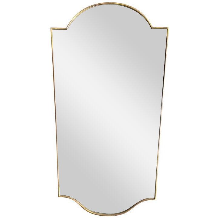 An original 1960s Italian shield mirror with brass frame and beveled mirror