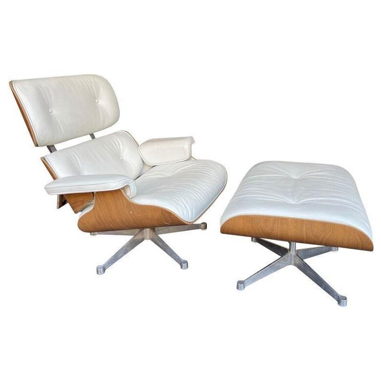 An original Eames lounger and ottoman by Vitra in "Snow" leather and Cherry wood