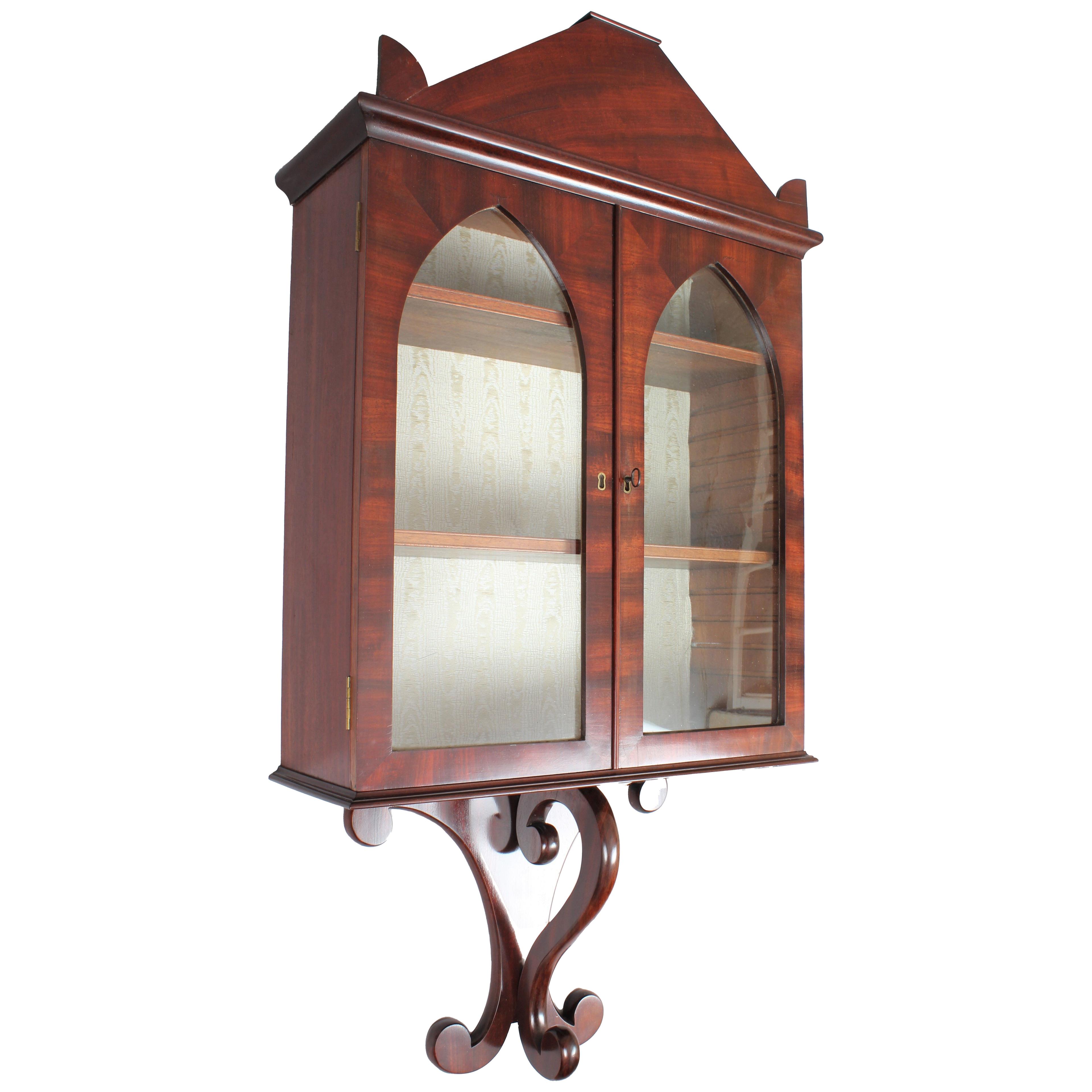 An unusual and good quality George IV period mahogany wall display cabinet
