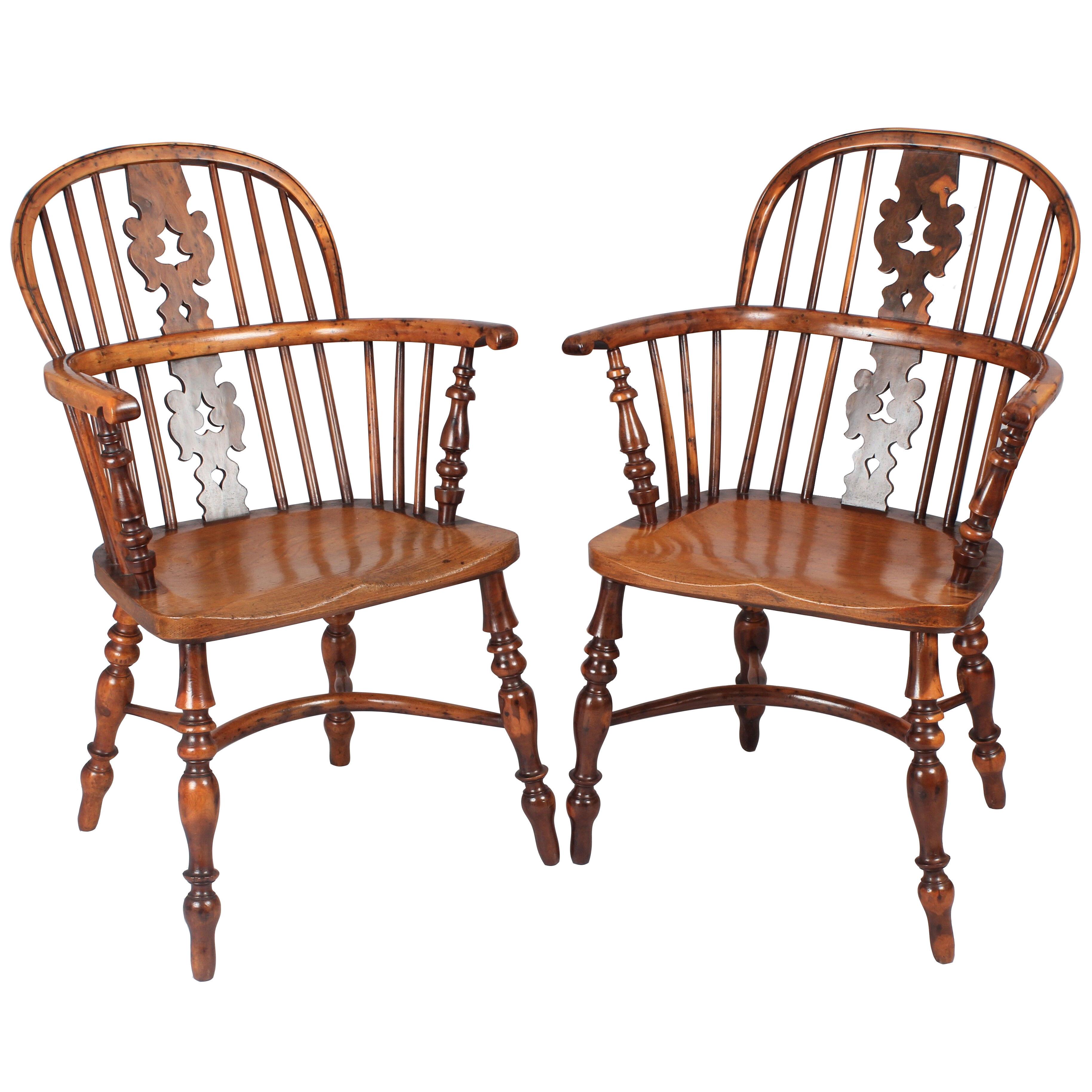 A fine pair of early 19th century yew Windsor arm chairs