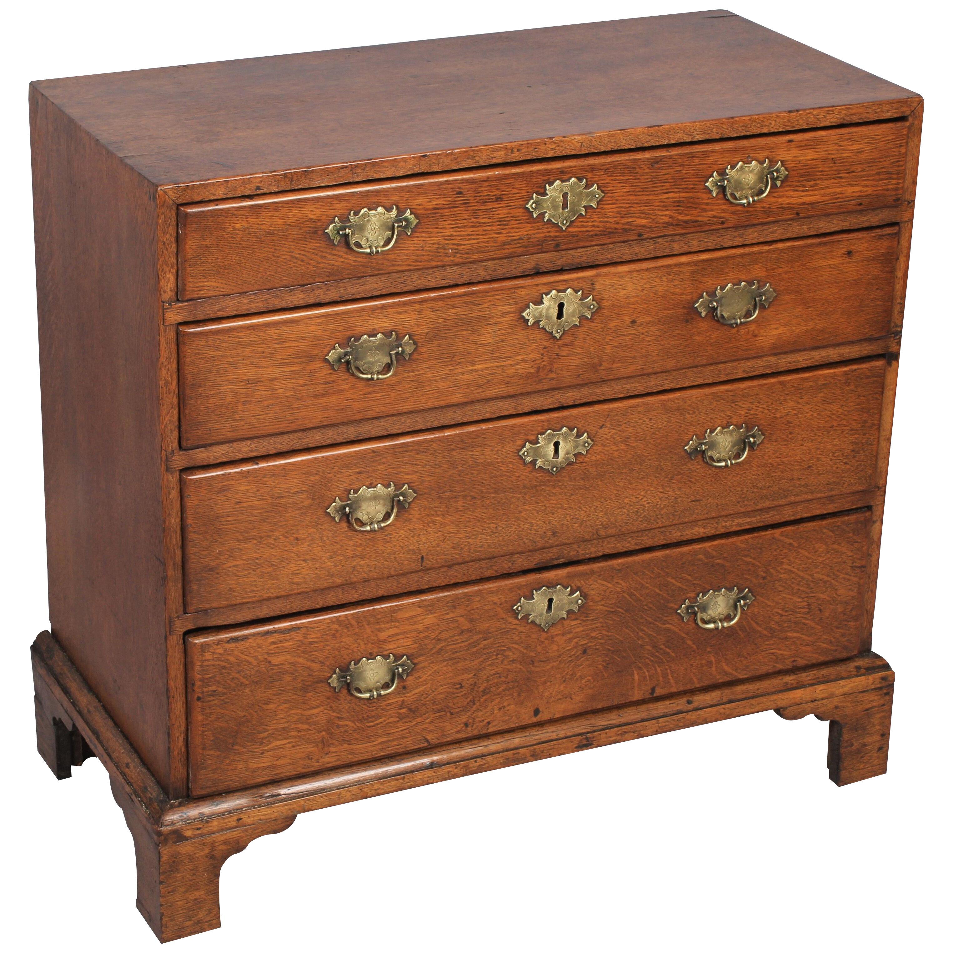 A rare George II period oak chest of drawers of diminutive size