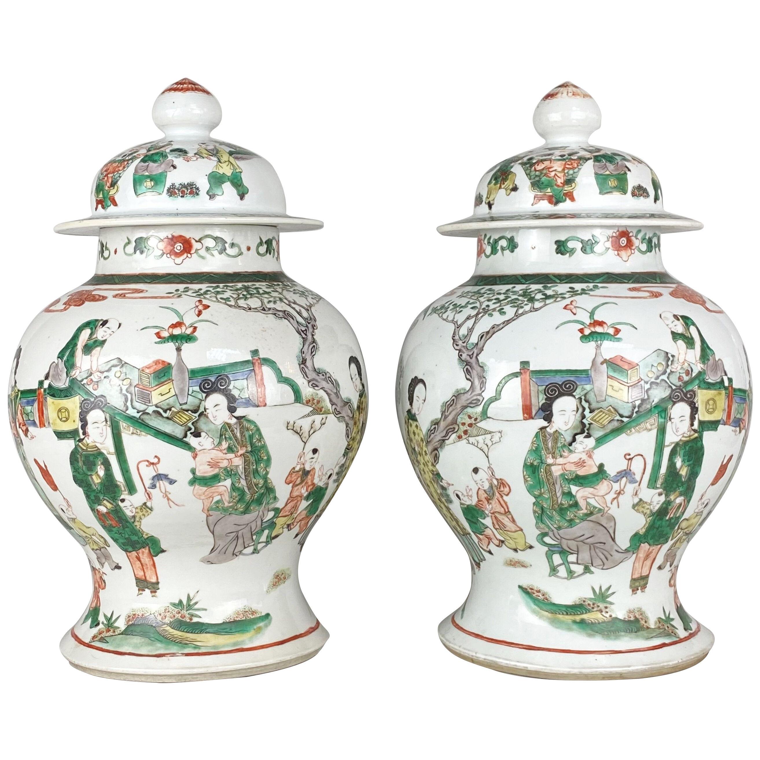 A charming pair of 19th Century Chinese famille verte jars and covers