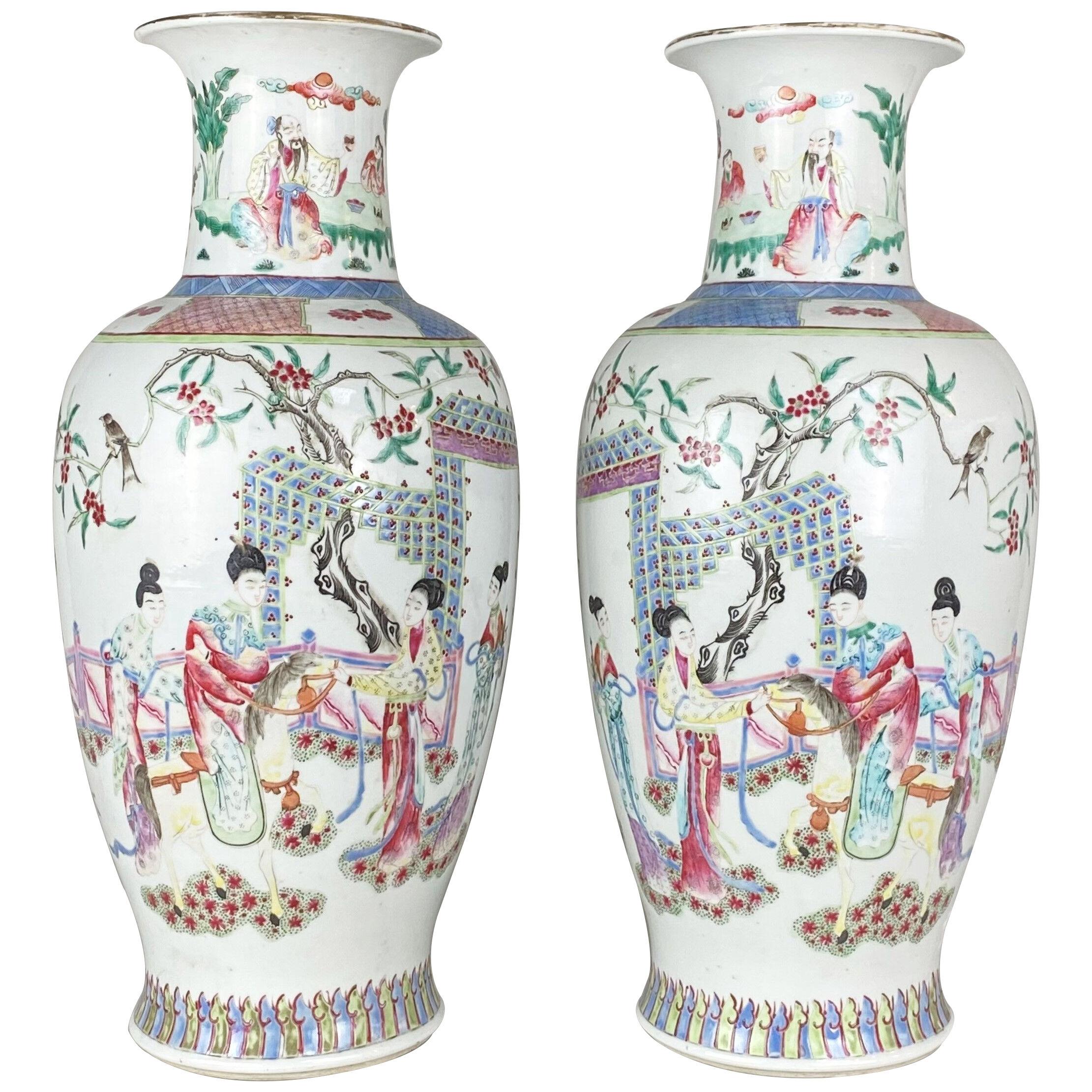 An ornate pair of white ground, famille rose vases (Chinese 19th Century)