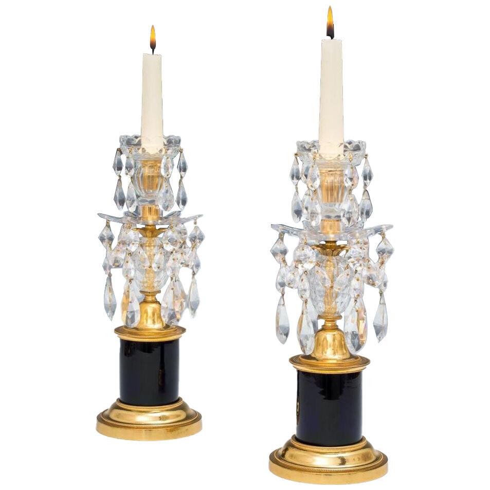A PAIR OF GEORGE III CANDLESTICKS WITH BLUE DRUM BASES