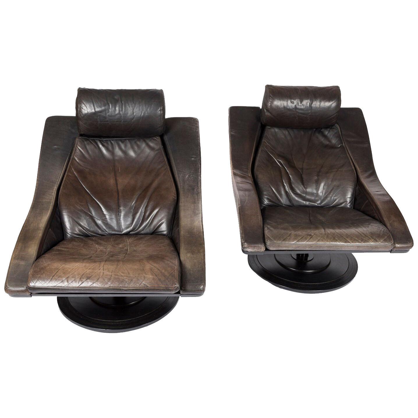 A pair of 1970s Swedish black swivel easy chairs