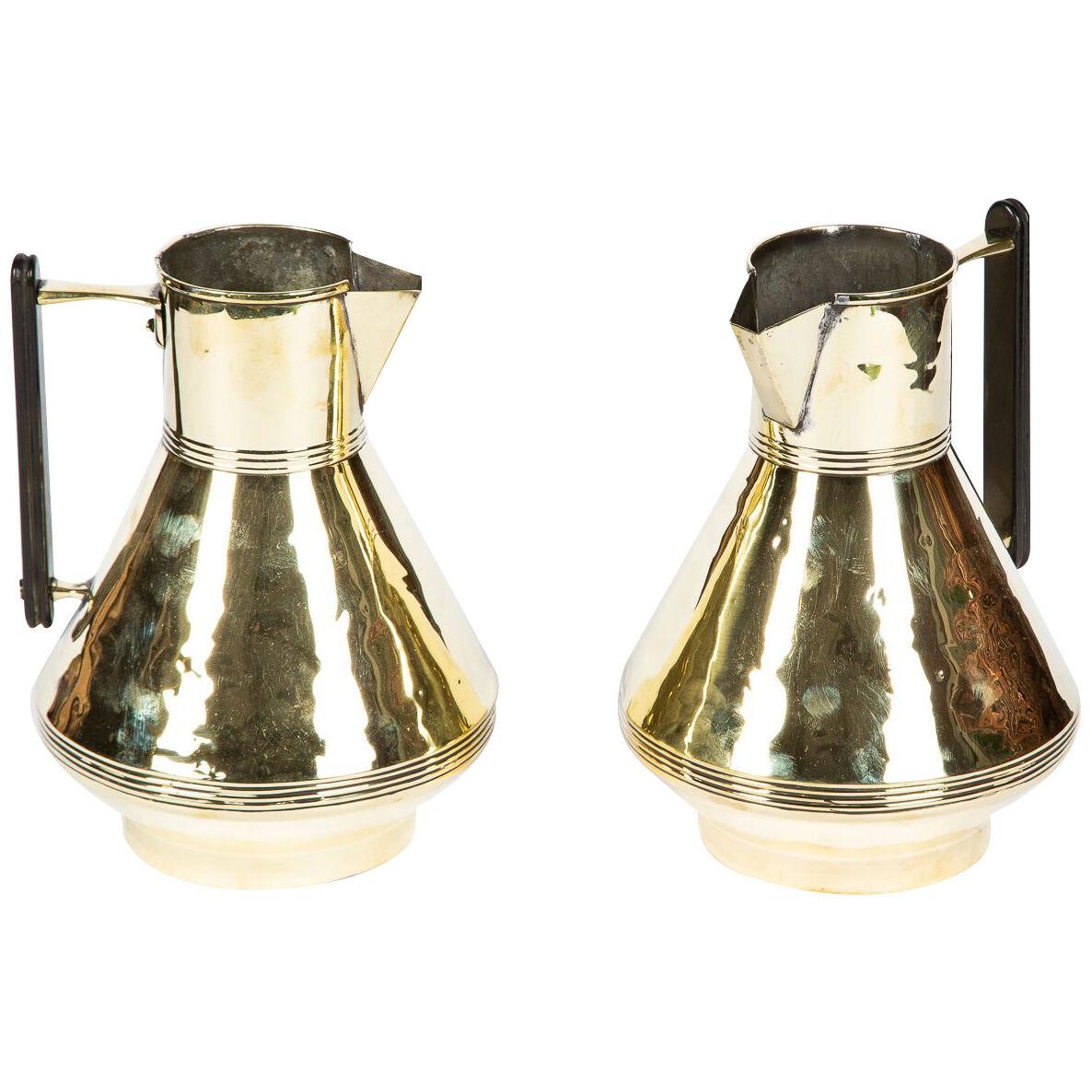 Pair of brass jugs by Fearncombe, designed by Christopher Dresser.