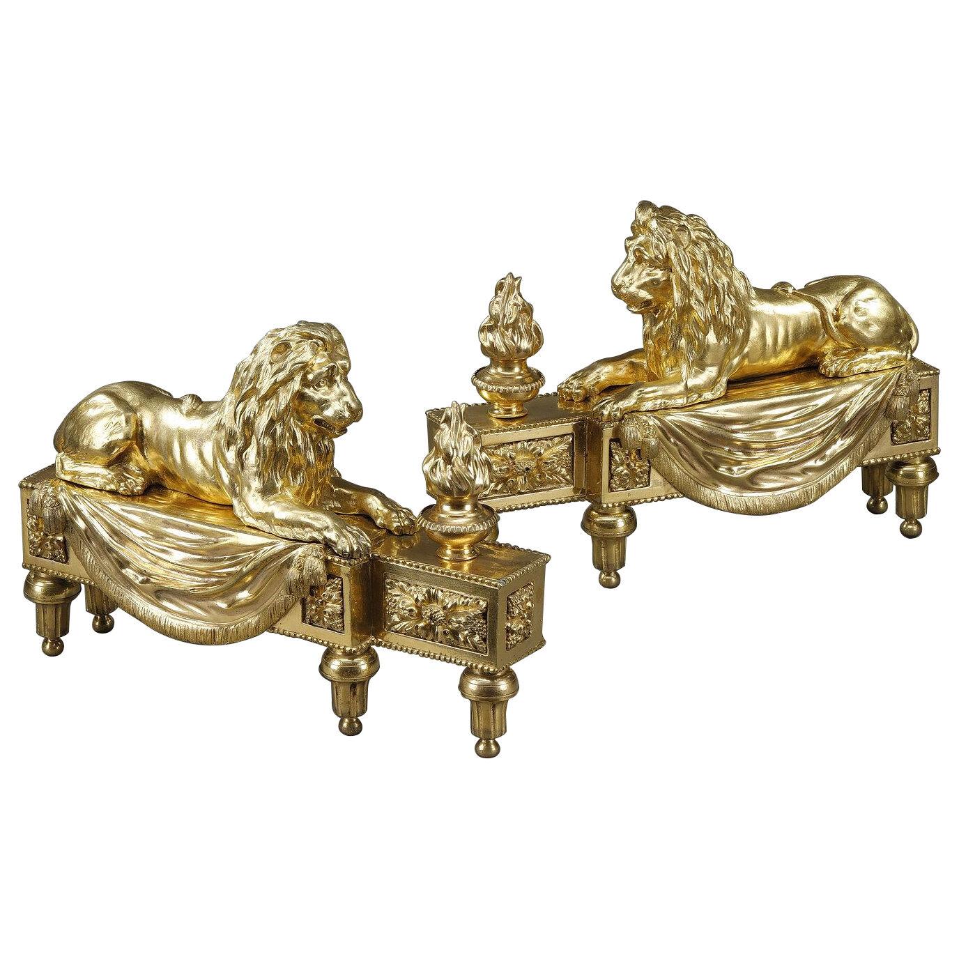 Pair of andirons with lions in gilded and chiseled bronze