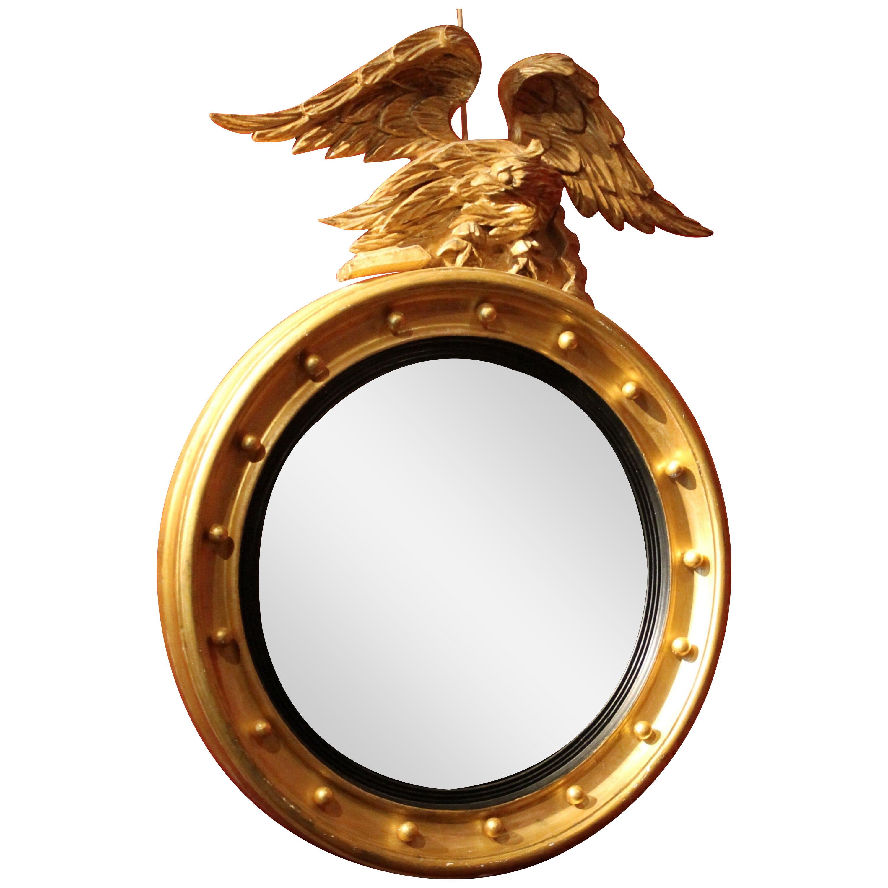 Italian Regency Round Giltwood and Ebonized Convex Mirror with Carved Eagle
