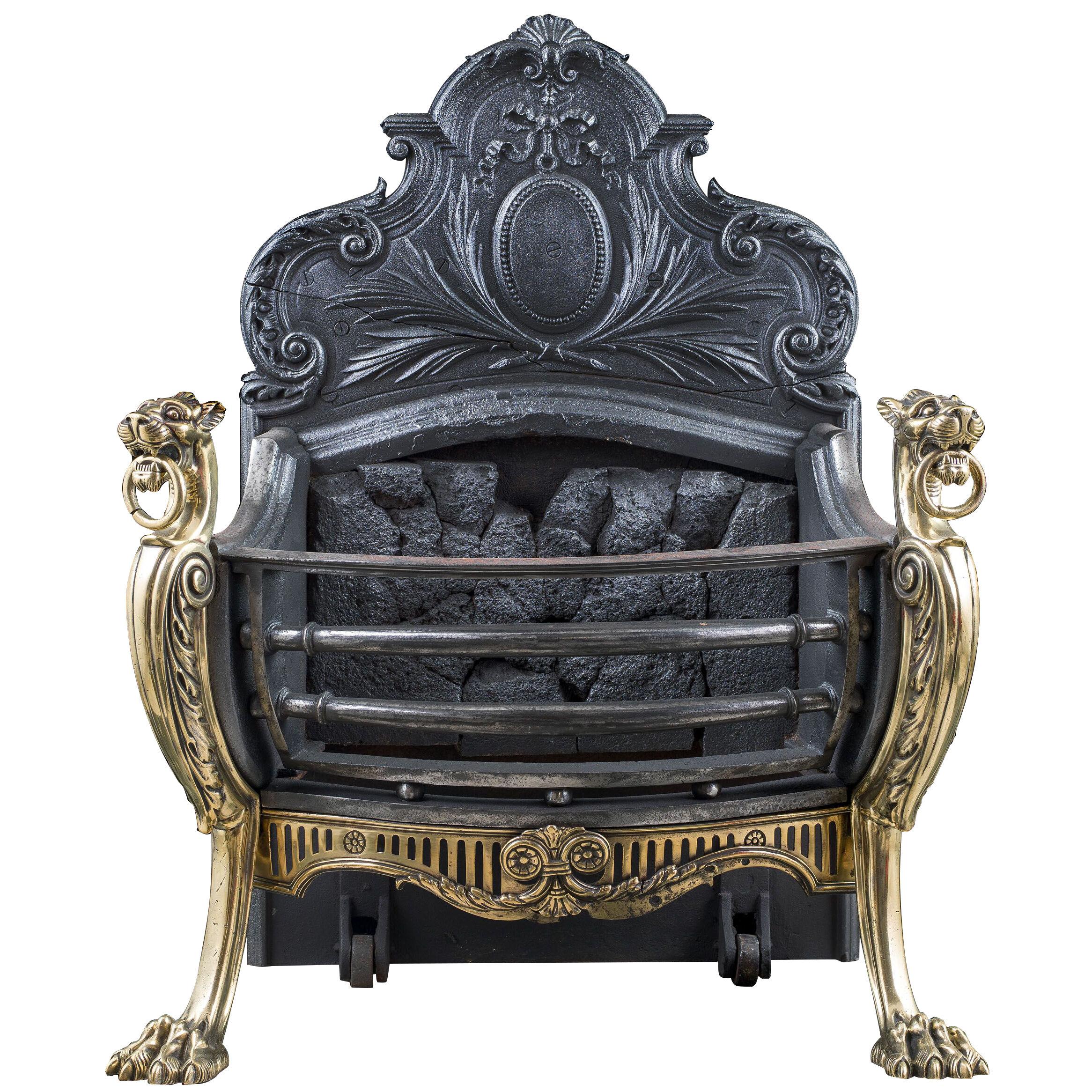 A Rococo style antique griffin fire basket