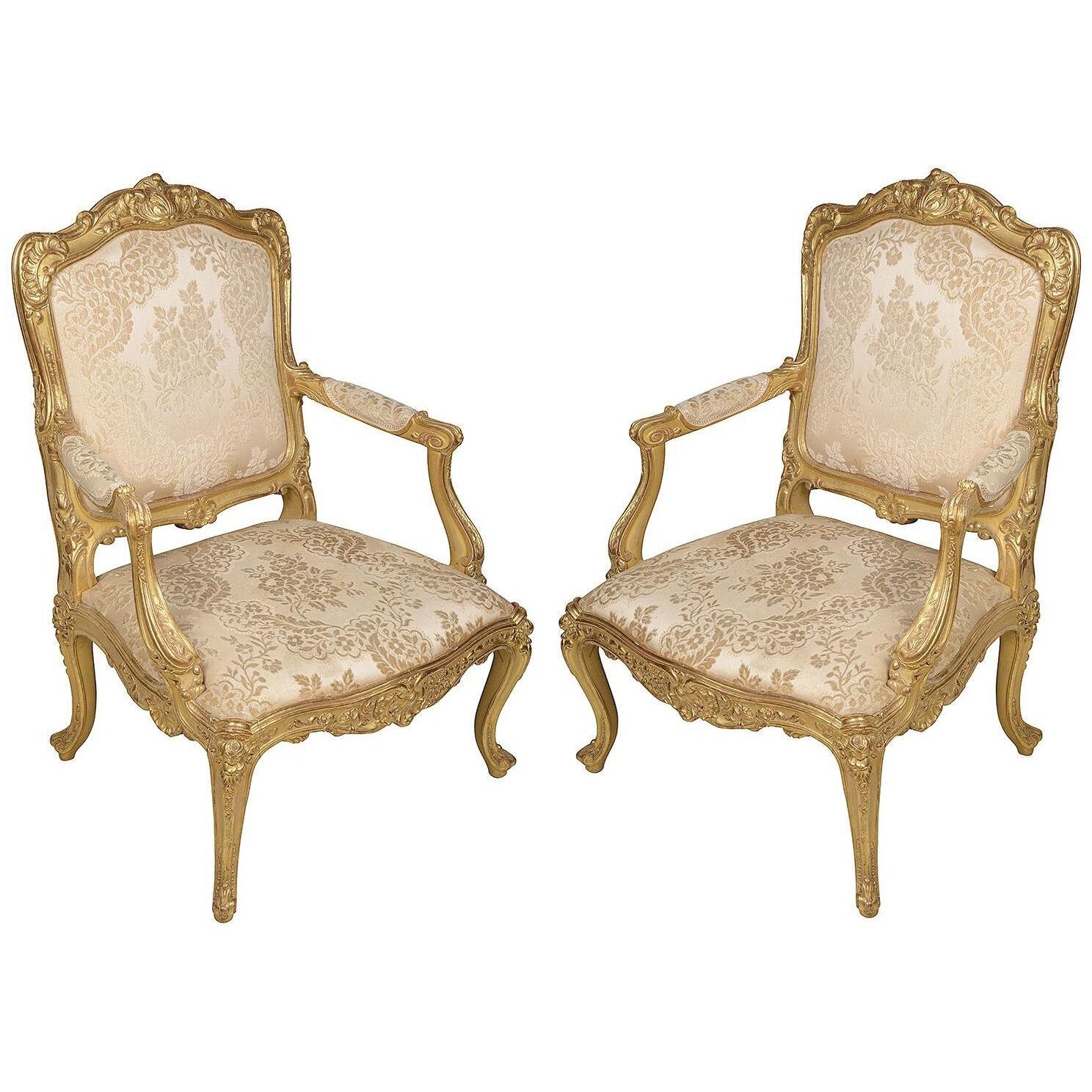Pair 19th Century French carved giltwood Louis XVI style arm chairs.