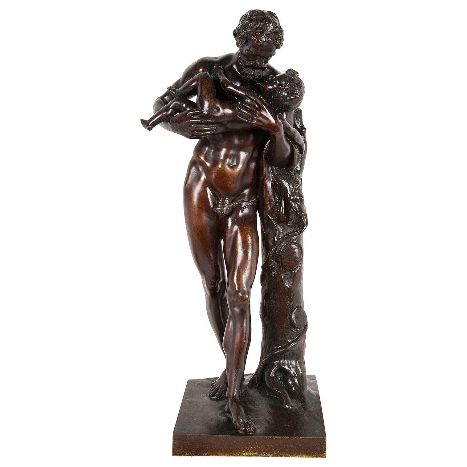 A Grand tour 19th Century Bronze statue of Silenus cradling the infant Dionysus.