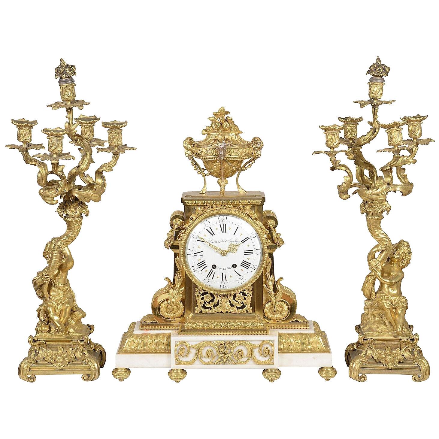 French Louis XVI style mantel clock + candelabra, 19th Century.